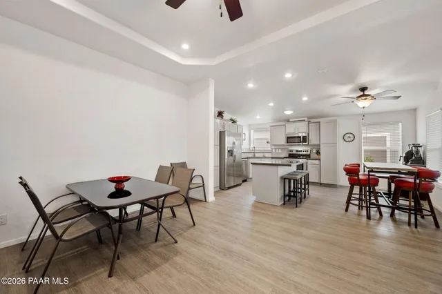 a dining room with furniture and wooden floor