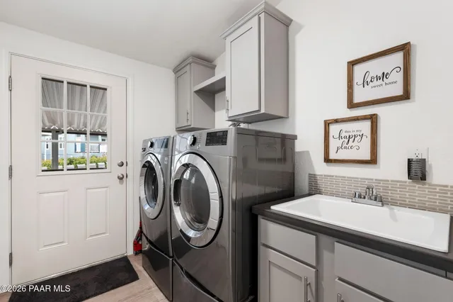 a bathroom with a sink a washer and dryer