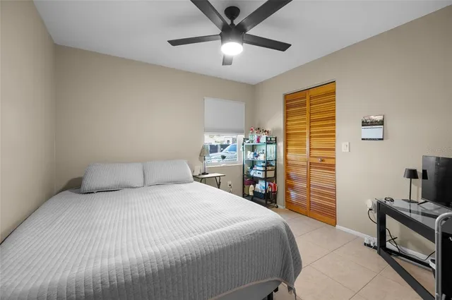 a bedroom with a bed and a television