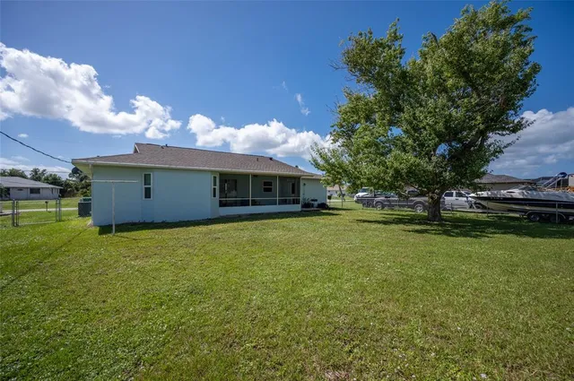 a front view of a house with a garden and yard