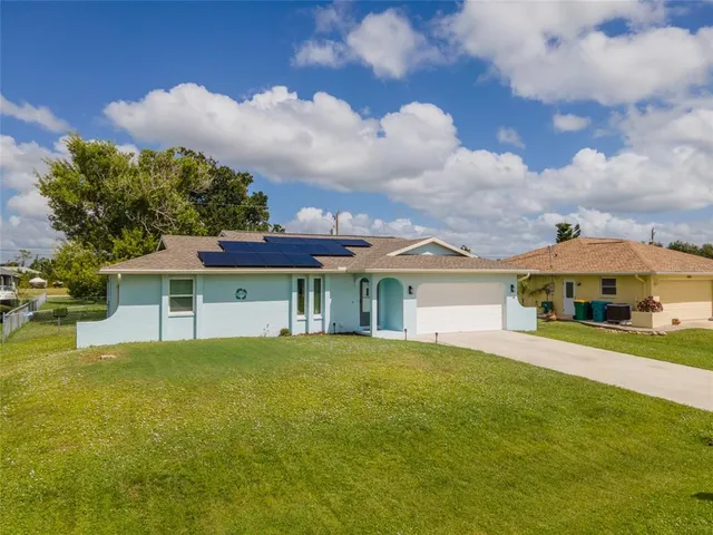 an aerial view of a house with swimming pool and lake view