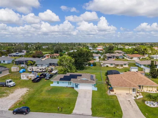 an aerial view of a house with a yard