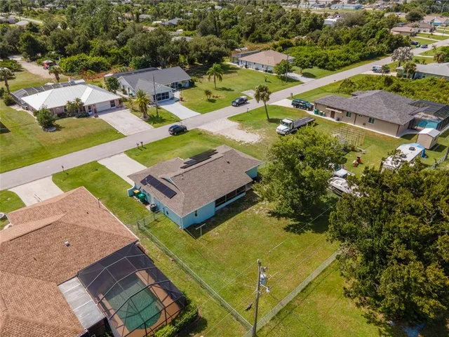 a view of a big yard with a house in the background