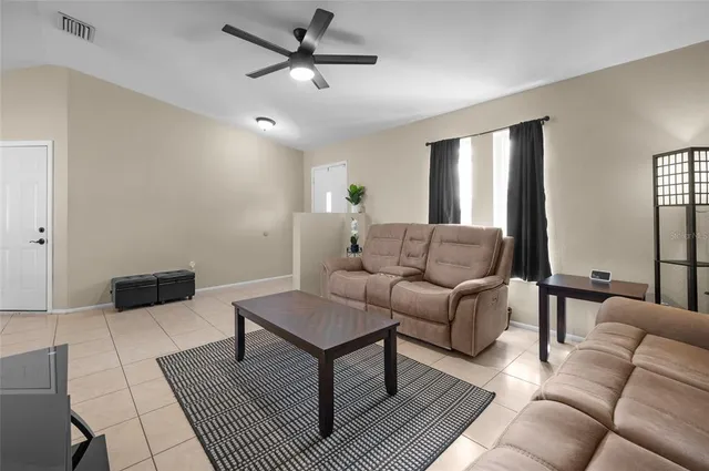 a living room with furniture and a rug
