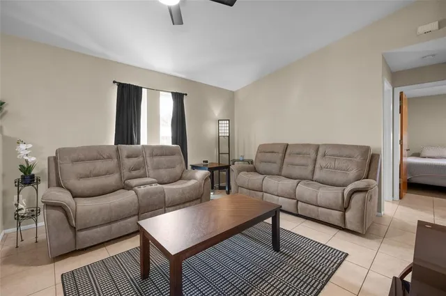 a living room with furniture a rug and a window