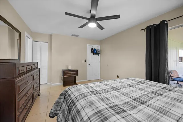 a bedroom with a bed and a television