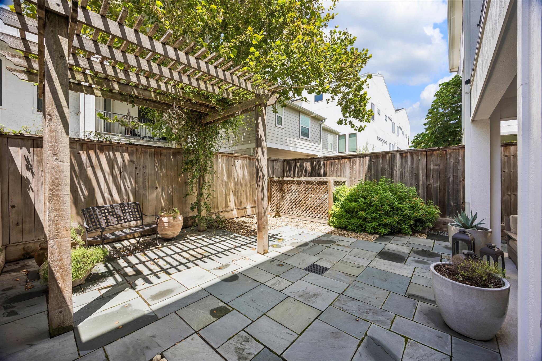 1810 Ridgewood Street Houston, TX 77006 - Photo 28 of 30 Gorgeous flagstone extends from the covered porch to the back fence, including beneath the pergola.