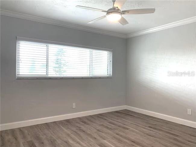 2451 Canadian Way, Unit 59 Clearwater, FL 33763 - Photo 12 of 58 wooden floor in an empty room with a window