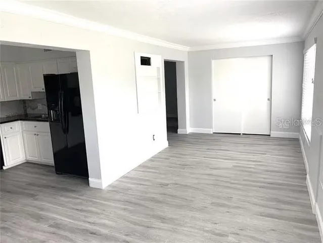 a view of a livingroom with an empty space and a window