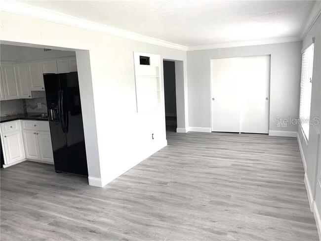 2451 Canadian Way, Unit 59 Clearwater, FL 33763 - Photo 20 of 58 an empty room with wooden floor and entrance