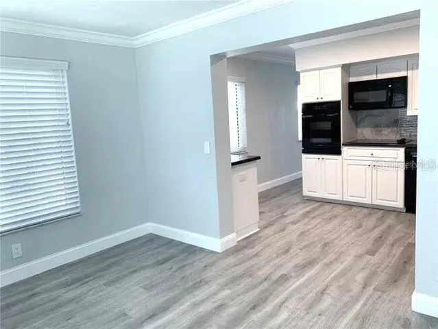 a kitchen with granite countertop a refrigerator and a sink