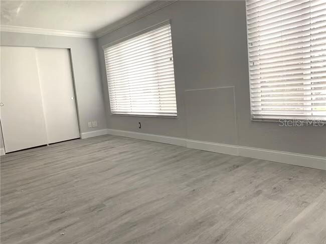 2451 Canadian Way, Unit 59 Clearwater, FL 33763 - Photo 24 of 58 a view of an empty room with wooden floor and a window