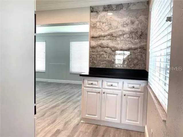 a kitchen with granite countertop stainless steel appliances and wooden cabinets