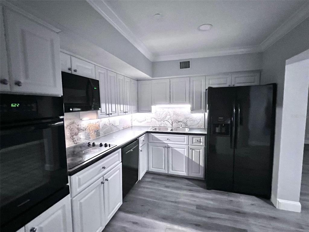 2451 Canadian Way, Unit 59 Clearwater, FL 33763 - Photo 28 of 58 a kitchen with granite countertop stainless steel appliances and wooden cabinets