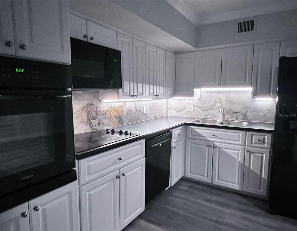 2451 Canadian Way, Unit 59 Clearwater, FL 33763 - Photo 30 of 58 a kitchen with granite countertop cabinets stainless steel appliances and a sink