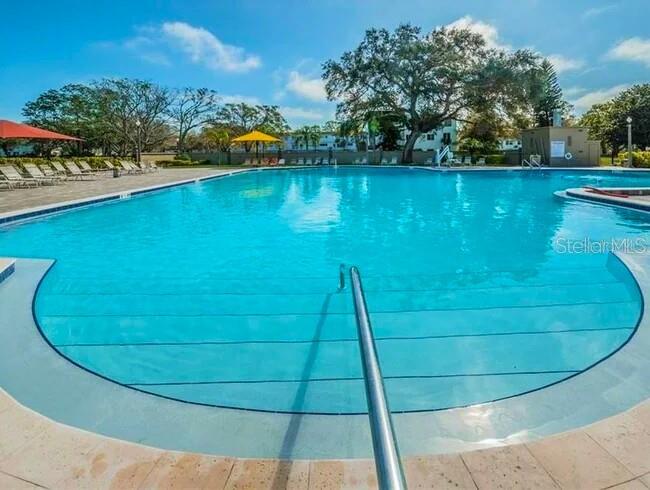 2451 Canadian Way, Unit 59 Clearwater, FL 33763 - Photo 42 of 58 a view of a swimming pool with an outdoor space and seating area