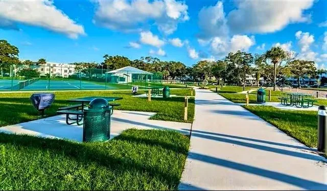 a street sign on a sidewalk next to a road