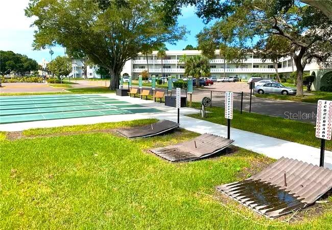2451 Canadian Way, Unit 59 Clearwater, FL 33763 - Photo 49 of 58 a view of a swimming pool with a patio and a yard