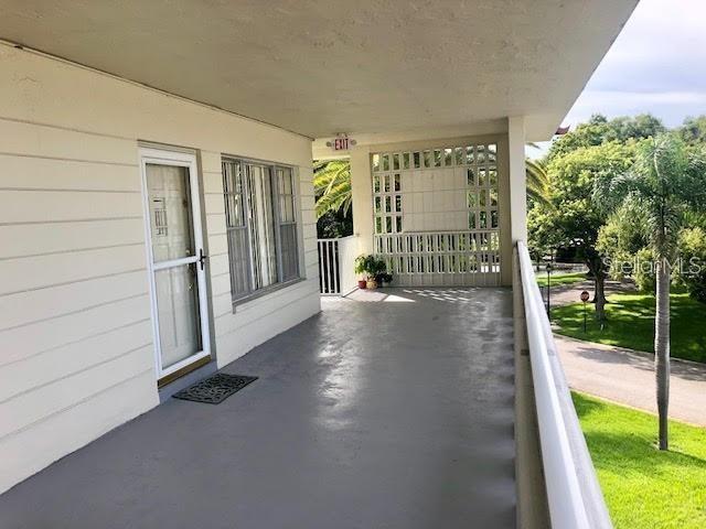 2451 Canadian Way, Unit 59 Clearwater, FL 33763 - Photo 9 of 58 a view of front door and porch with seating space