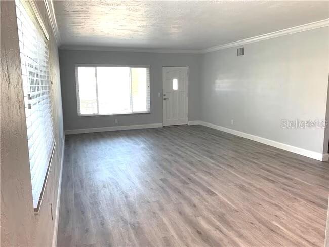 2451 Canadian Way, Unit 59 Clearwater, FL 33763 - Photo 10 of 58 an empty room with wooden floor and windows
