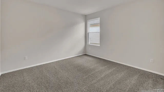 a view of an empty room and a window