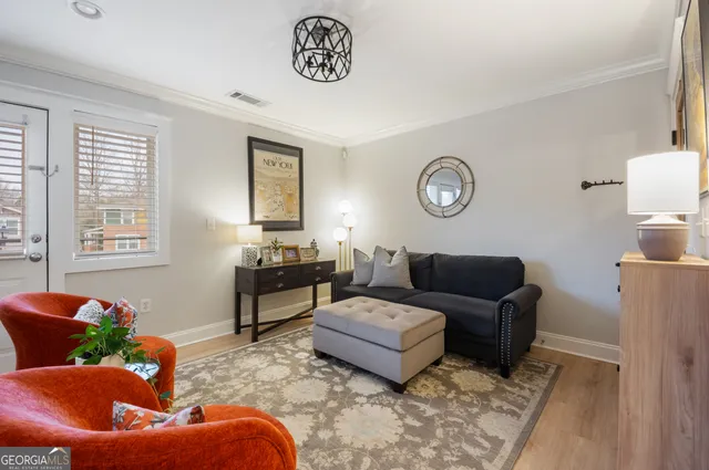 a living room with furniture wooden floor and window