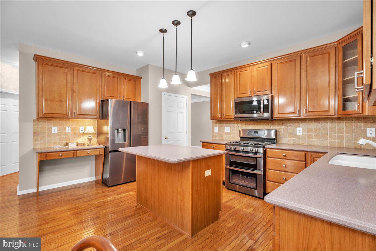 68 Hillside Lane Mount Laurel, NJ 08054 - Photo 9 of 36 a kitchen with stainless steel appliances granite countertop a stove top oven a refrigerator a sink dishwasher and a cabinets with wooden floor