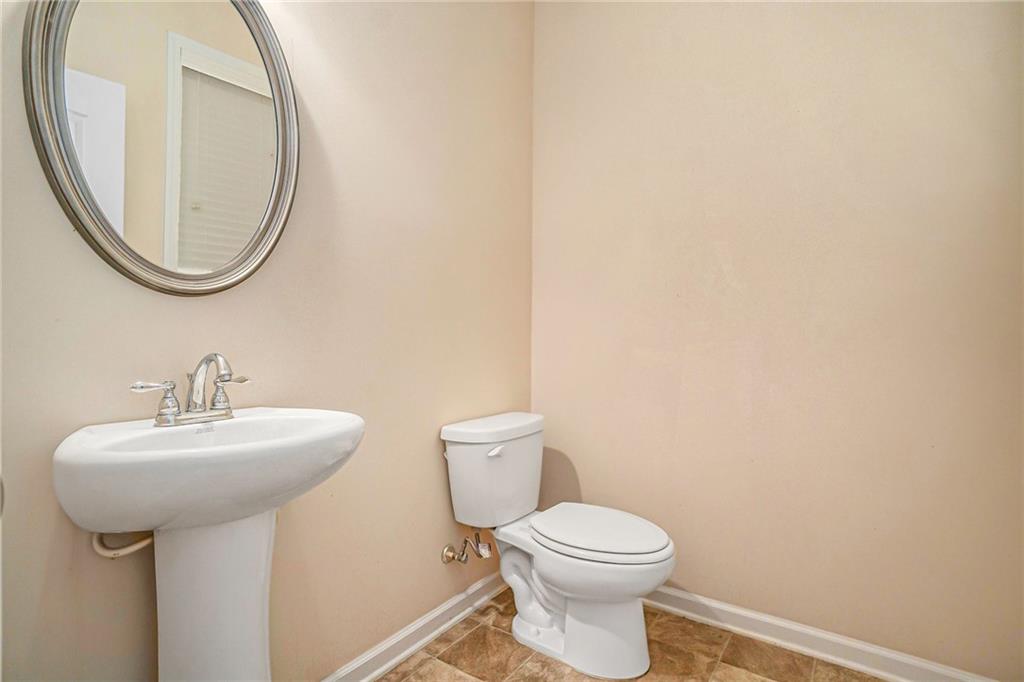 1736 Walton Reserve Way Austell, GA 30168 - Photo 13 of 35 a bathroom with a sink a mirror and a toilet