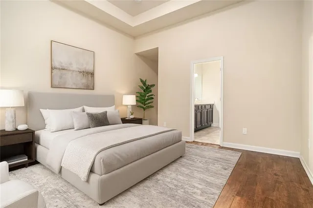 a bedroom with a bed and a painting on the wall