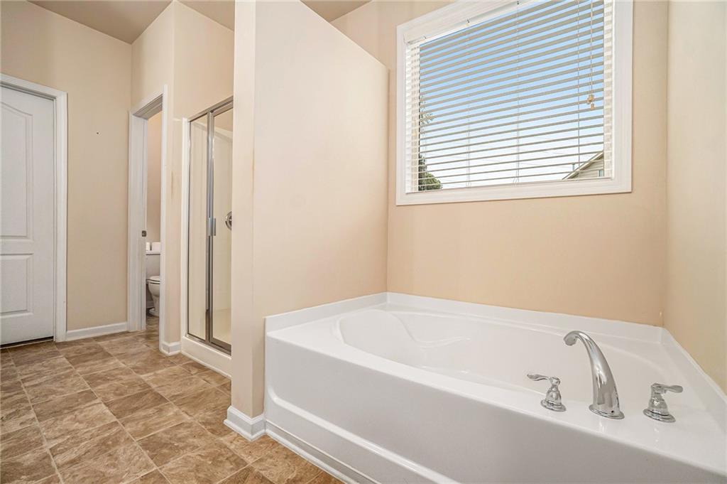 1736 Walton Reserve Way Austell, GA 30168 - Photo 19 of 35 a white bath tub sitting next to a window