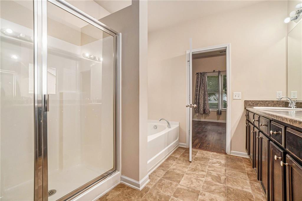 1736 Walton Reserve Way Austell, GA 30168 - Photo 20 of 35 a bathroom with a tub a sink and a mirror