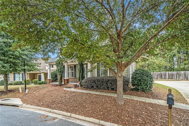 a front view of a house with garden