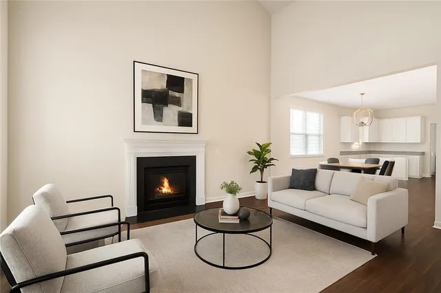 a living room with furniture a fireplace and a potted plant
