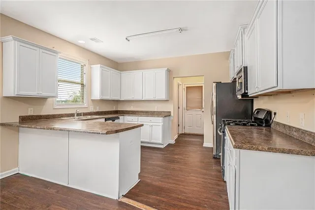 a kitchen with a stove a sink and a refrigerator