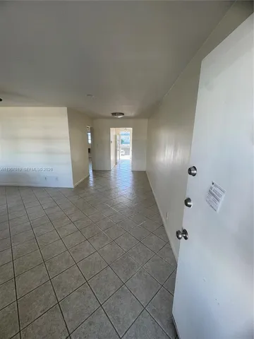 a view of an empty room and a window