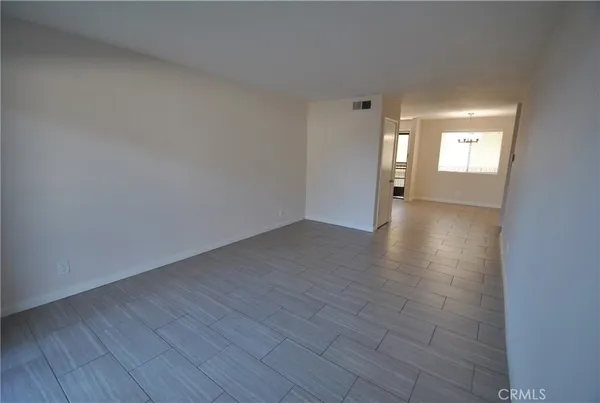 an empty room with mirror and window