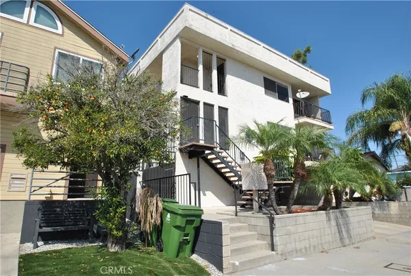 a front view of a house with a tree