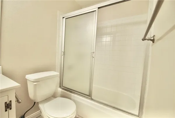 a bathroom with a sink a toilet a mirror and vanity