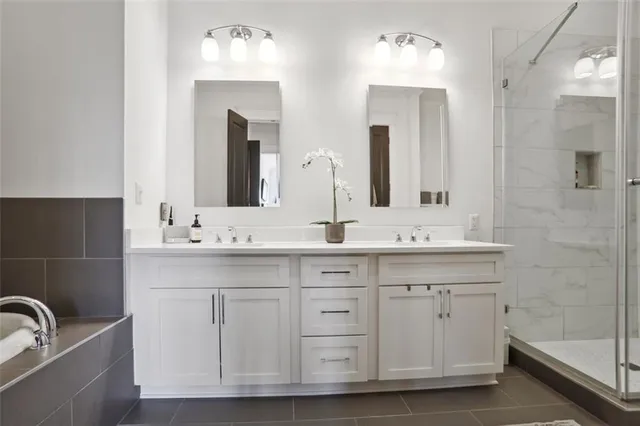 a bathroom with a double vanity sink and a mirror