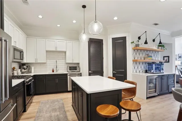 a kitchen with cabinets and wooden floor