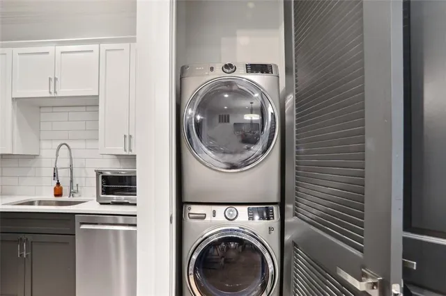 a utility room with sink dryer and washer
