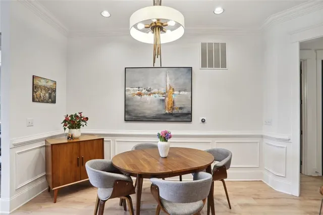 a view of a dining room with furniture wooden floor and a chandelier