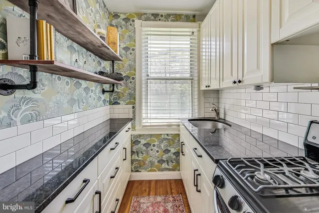 a kitchen with stove and cabinets