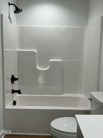 a bathroom with a toilet and a bathtub