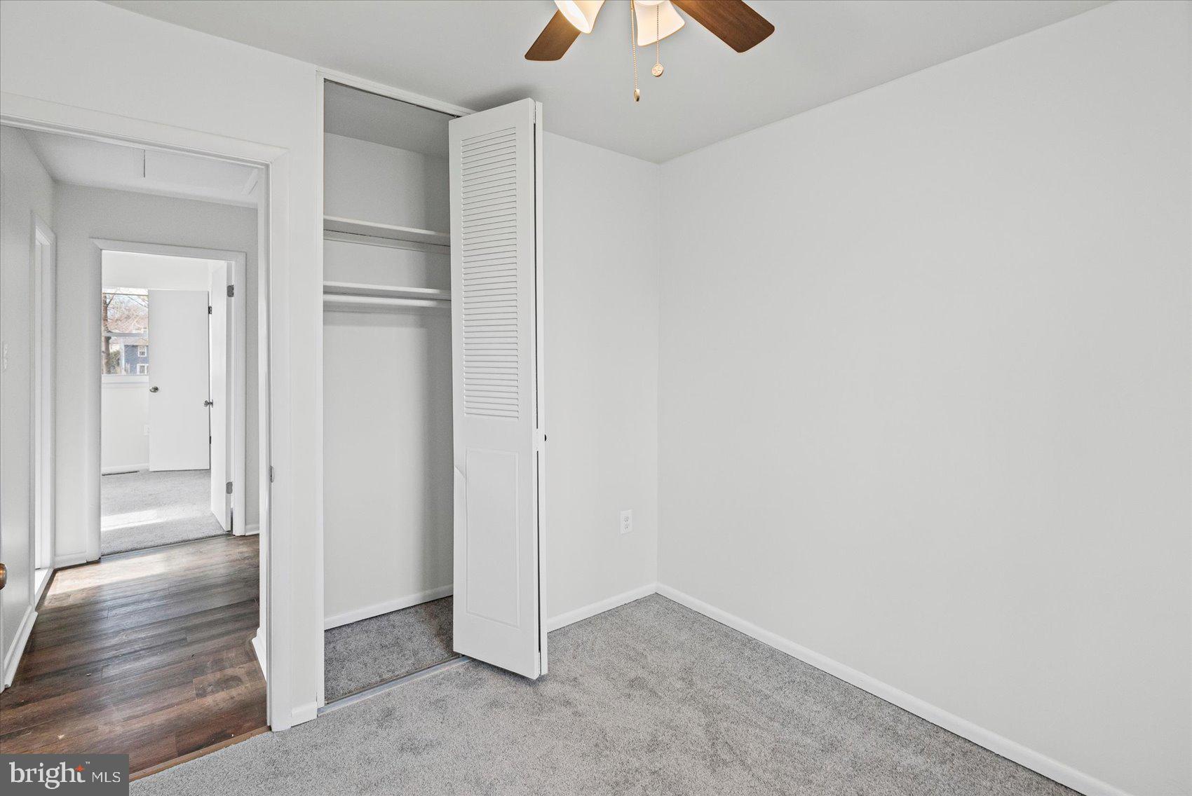 331 Laburnum Road Edgewood, MD 21040 - Photo 21 of 41 an empty room with wooden floor a ceiling fan and windows