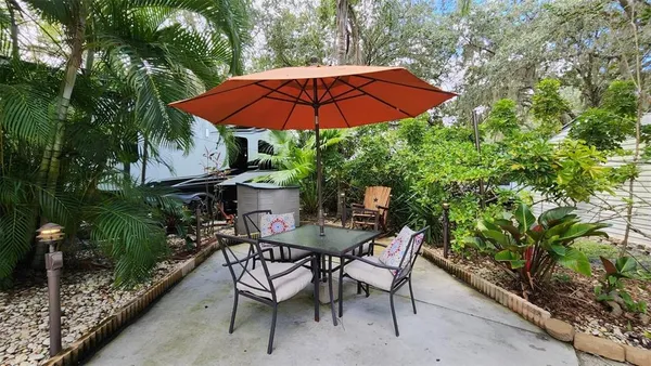 a patio with a patio table and chairs