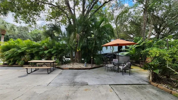 a backyard view with a seating space