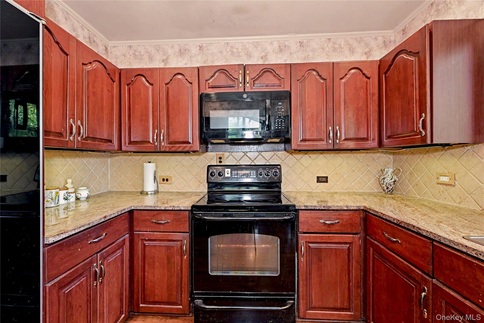 631 Croton Falls Road Carmel, NY 10512 - Photo 8 of 43 a kitchen with granite countertop a stove top oven microwave oven cabinets and a counter space