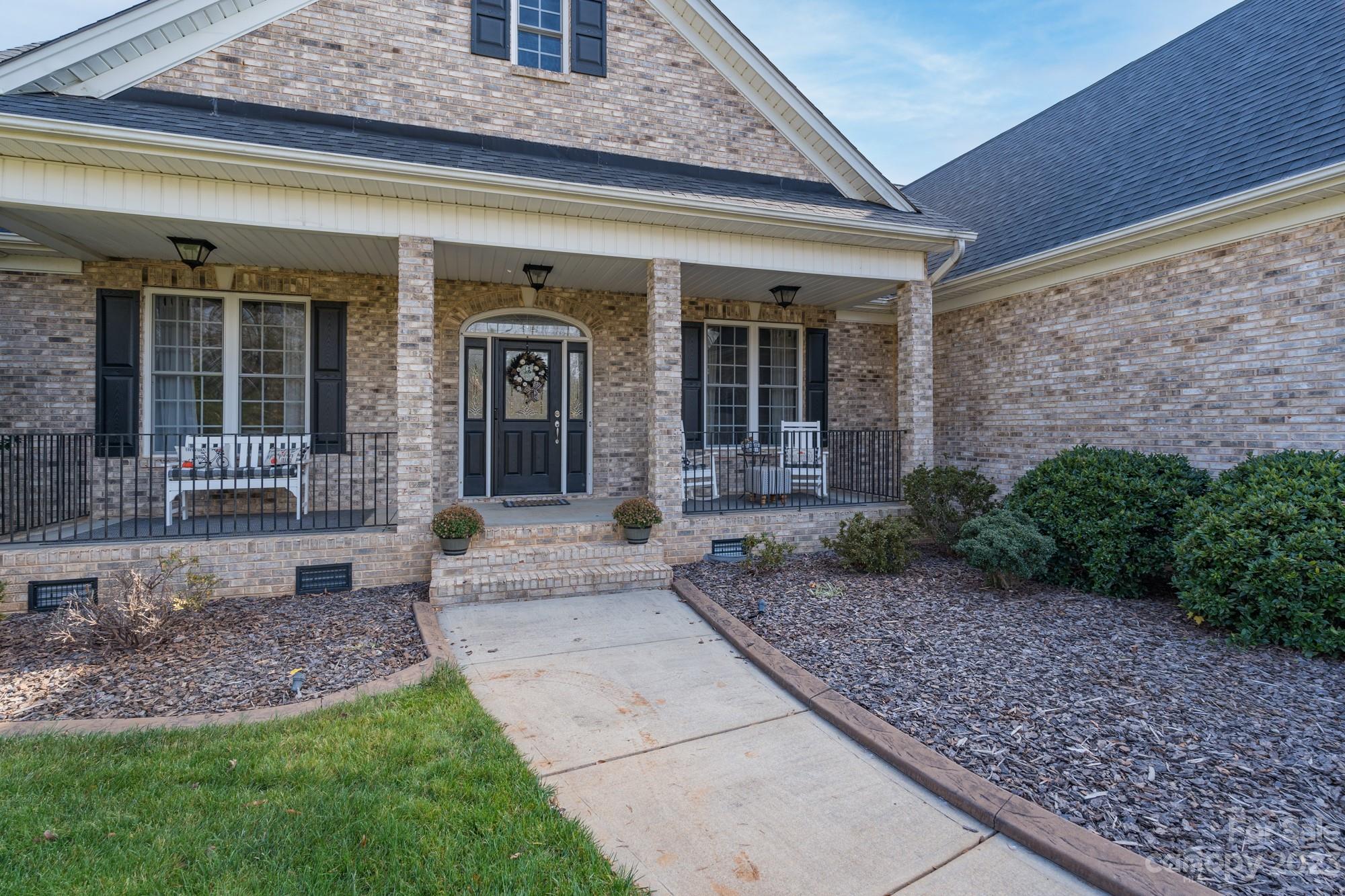 5896 Morning Star Road Lake Wylie, SC 29710 - Photo 4 of 40 a front view of a house with garden