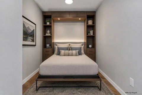 a bed sitting in a bedroom next to a window